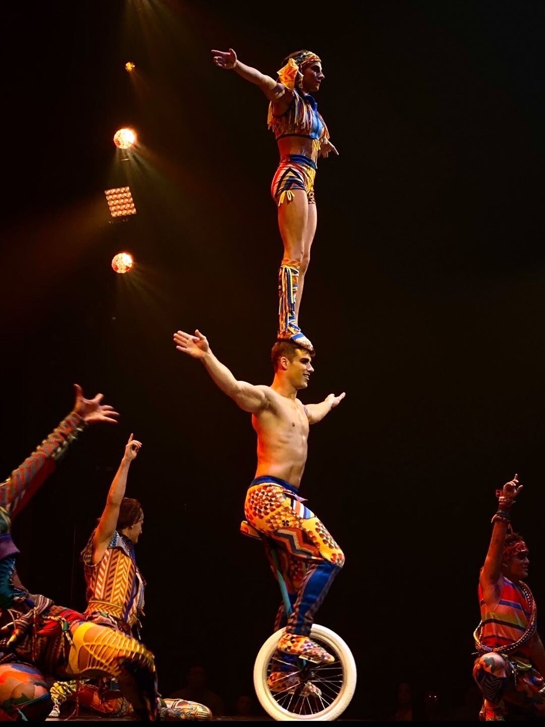 Marie-Lee balances above Philippe on a unicycle during VOLTA